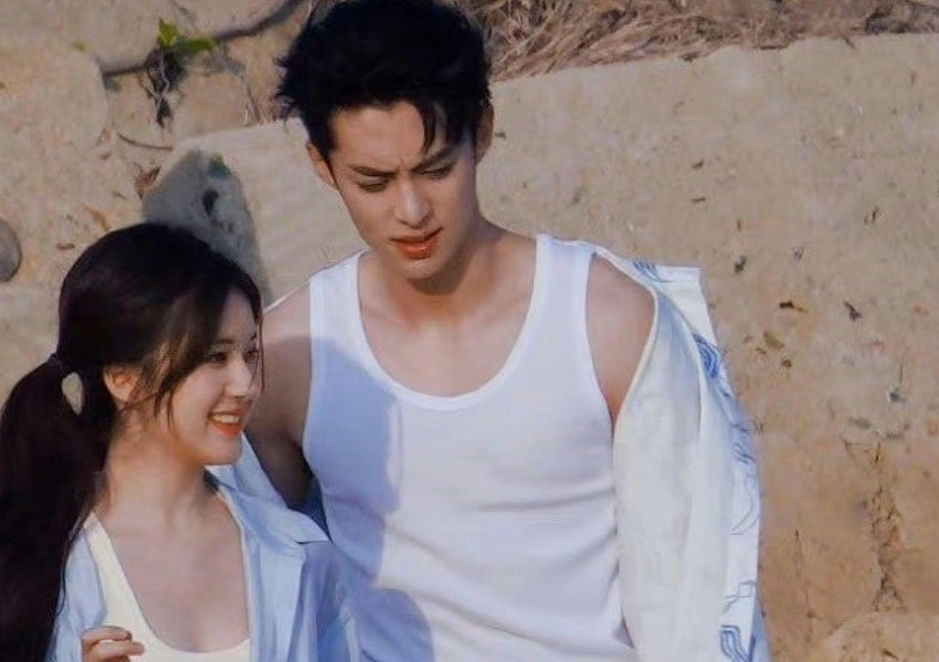 people-Dylan Wang (Wang Hedi)-smiling female companion-beach setting-white tank top-light blue shirt