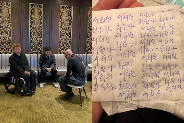 people-Man in wheelchair-Black suit-Man sitting-Black suit-Man sitting sideways-Dark clothing-Korean writing on napkin