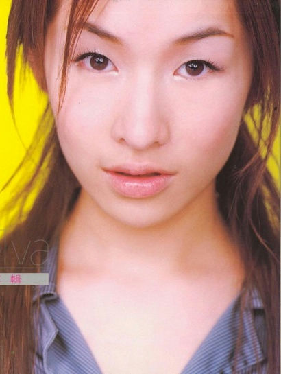 people-Asian woman-A-close-up portrait-A-yellow background-B-long brown hair-B-blue collared shirt-C
