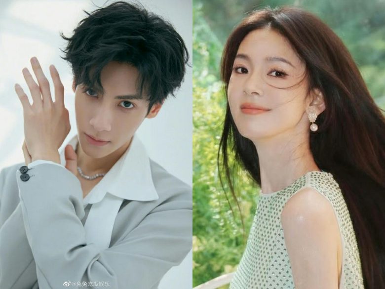 people-Male actor (left)-Black messy hair-Light gray suit and white shirt-Diamond necklace-Female actress (right)-Long dark brown hair-Light green sleeveless top-Pearl dangle earrings-Outdoor setting
