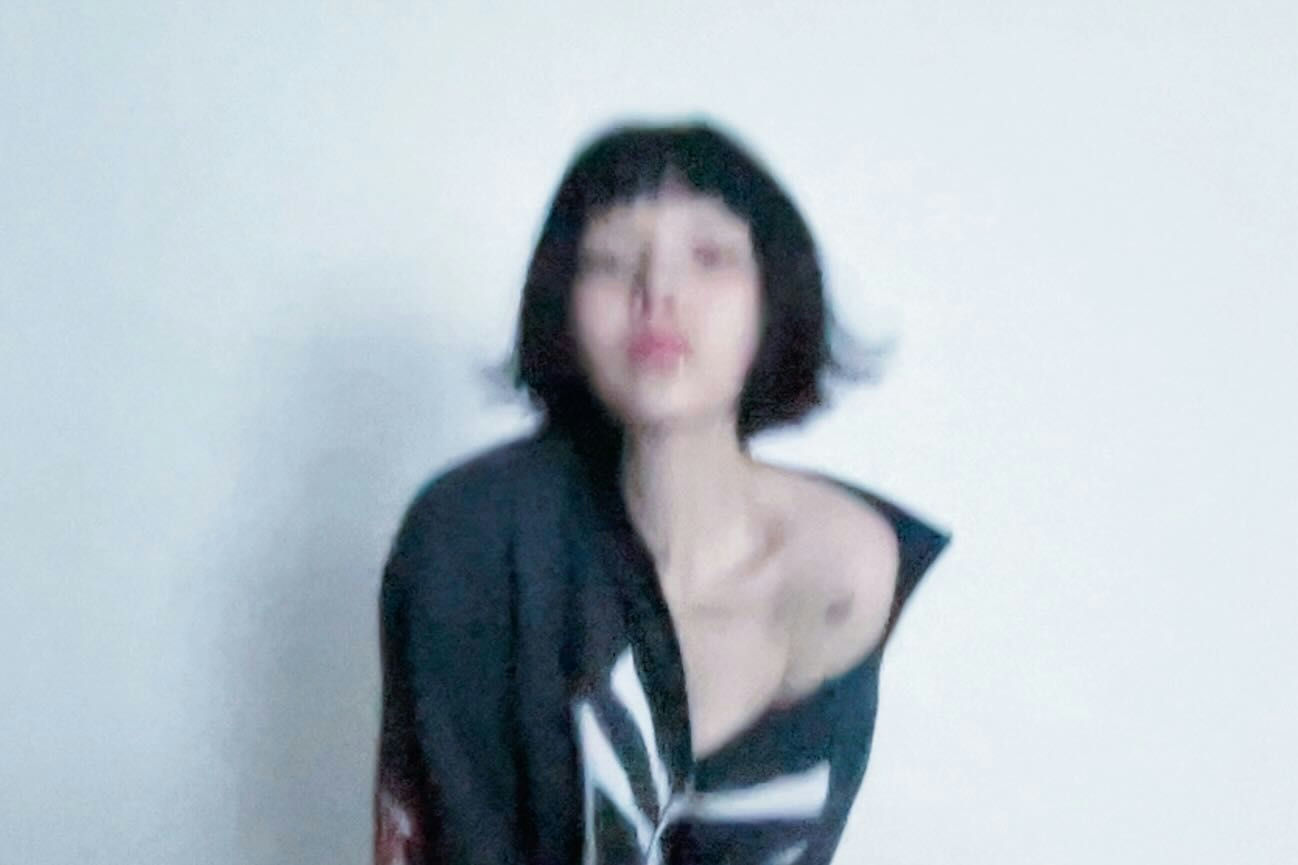 people-woman-A-short black hair-A-minimalist background-B-blurry-C-off-the-shoulder black top