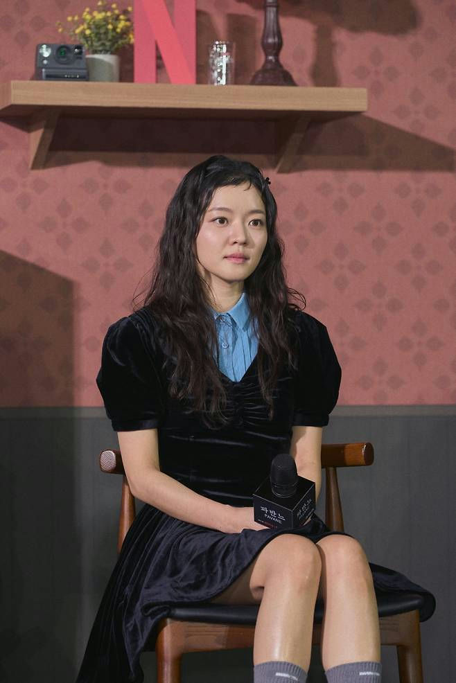 people-Kim Go-eun-sitting-black velvet dress-blue collared shirt-curly dark hair-grey knee-high socks