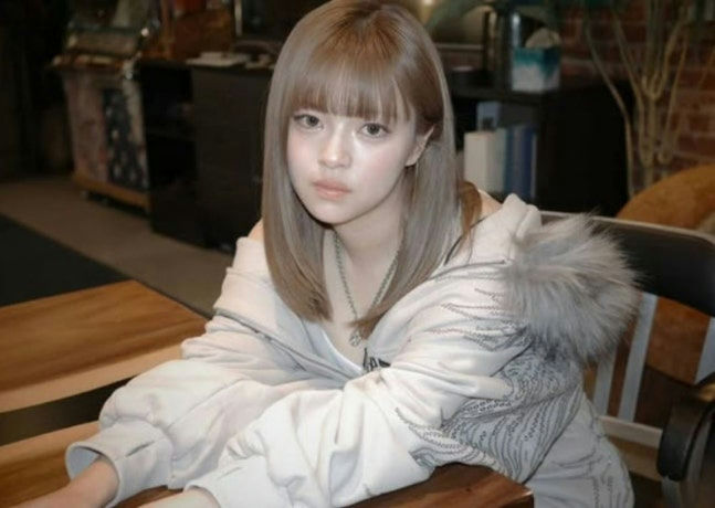 people-Japanese singer-A-Miyavi-A-white zip-up hoodie with grey embroidery and fur-trimmed hood-B-light brown/ash blonde hair with straight bangs-C