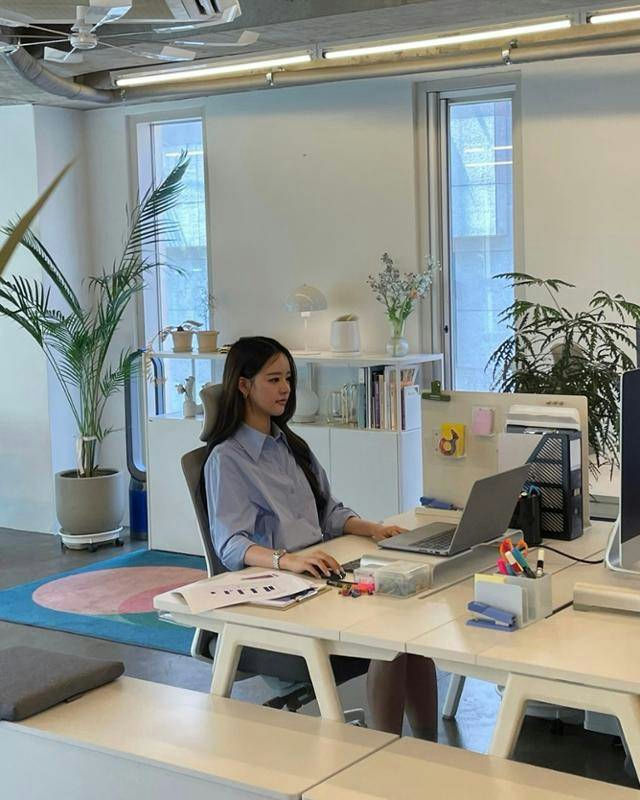 people-woman-office worker-indoors-laptop-desk-light blue shirt