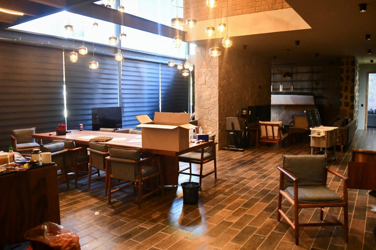 people-no person appearing-A-interior space-A-dining/conference area-B-stone and wood architecture-B-pendant lighting-C-moving boxes visible-C