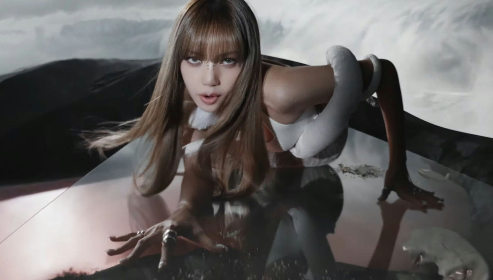 Lisa (BLACKPINK)-A-crawling pose-A-long brown hair with bangs-B-white costume element/snake-like wrapping-C-dark, moody background