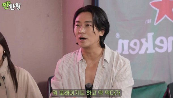 *people-Korean man-talking-open collar shirt-dark hair-Heineken logo background*