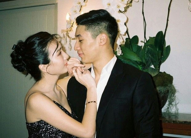 people-Couple-A-Intimate moment-A-Formal attire-A-Woman kissing man's hand-A-Orchids in background-A-Woman in black sequin dress-A-Man in black suit-A-Asian descent-A-Romance-A-Celebration-A-Korean celebrity-A-Park Seo-joon-A-Park Hyung-sik-A-Choi Woo-shik-A-Kim Tae-hyung-A-Park Seo-joon-A-Park Seo-joon-A-Park Seo-joon