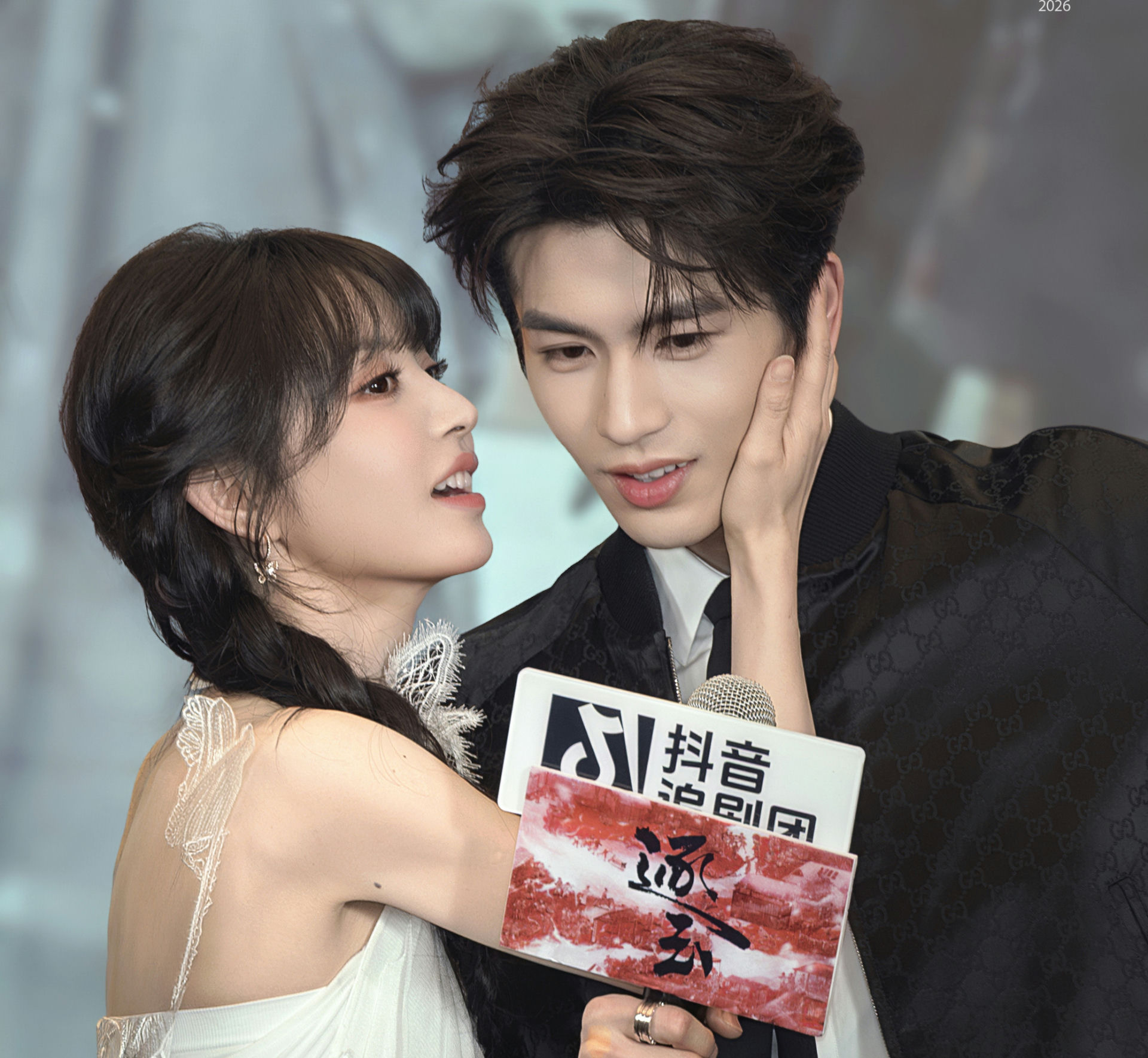 people-Bai Lu and Wang Hedi-intimate interaction-A-touching face-B-holding microphone sign-C-Gucci jacket