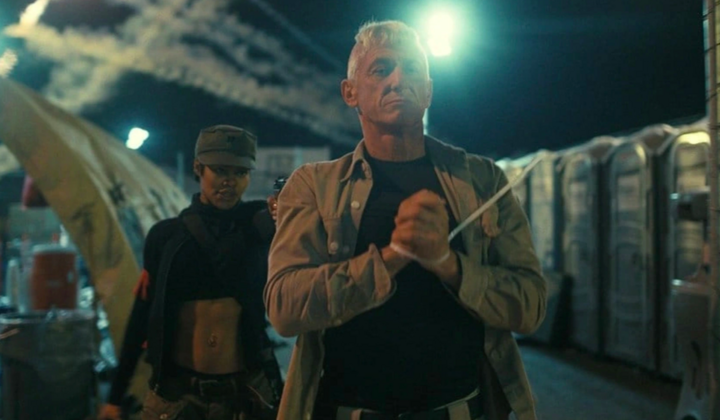 people-man with white hair tied up-woman with military cap and crop top-night scene-portable toilets-suspense