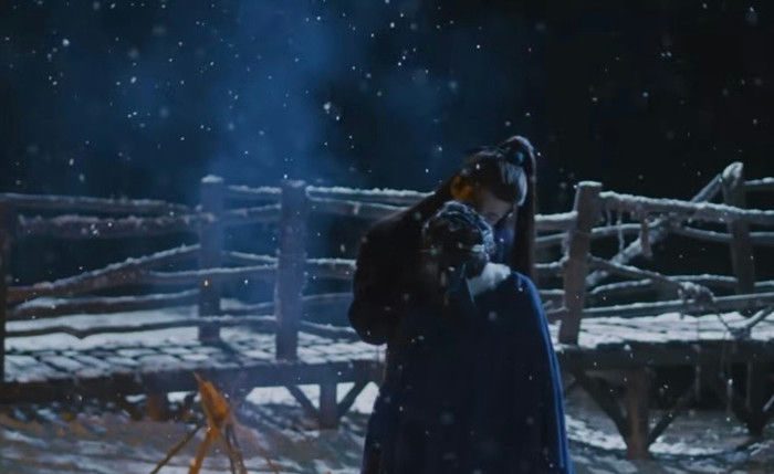 people-Two figures embracing-A-winter night-B-snow falling-C-wooden structure