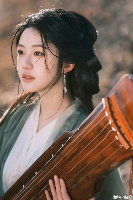 people-Young East Asian woman-A-Traditional Chinese attire-A-Guqin (Chinese zither)-B-Soft natural lighting-B-Elegant pose-C-Outdoor setting-C