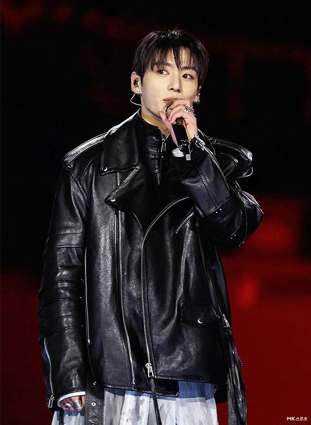 people-Jungkook (BTS)-performing-A-black leather motorcycle jacket-A-microphone-A-stage lighting
