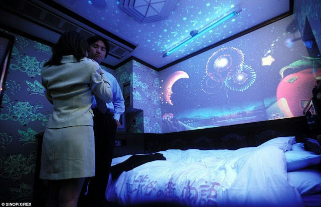 people-woman in light suit-A-man in blue shirt-B-bedroom with projection-C-glow-in-the-dark decor