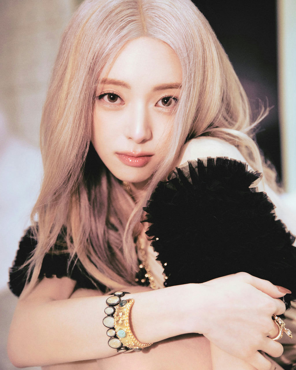 people-Rosé (BLACKPINK)-A-platinum blonde hair-A-light pinkish tint-B-black ruffled garment-B-gold cuff bracelet-C-intense gaze