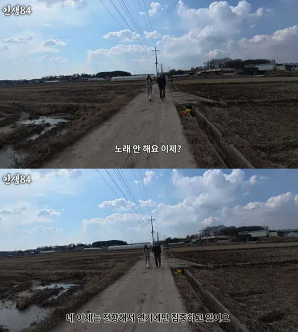 people-Two people walking on a dirt road in the countryside-A-clear blue sky with white clouds-B-Korean text overlay saying