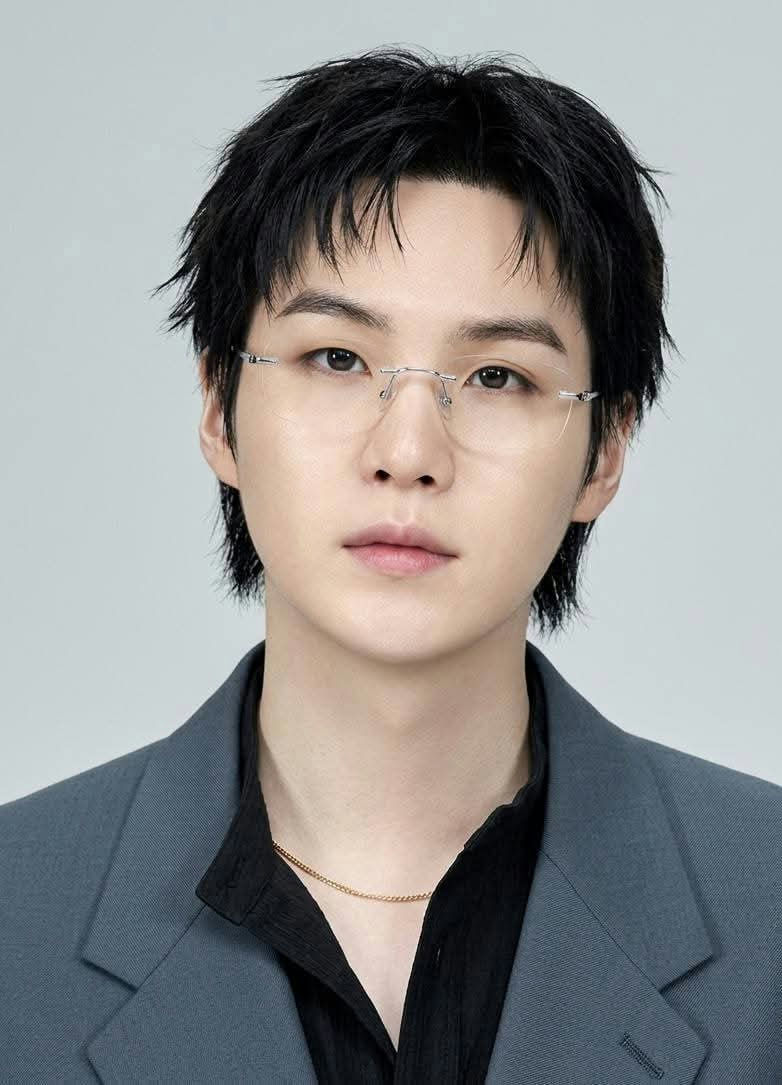 people-Suga (Min Yoongi)-rimless glasses-black messy hair-grey blazer-black shirt-gold chain