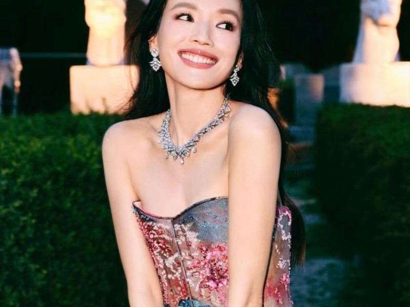 people-Shu Qi-smiling-A-diamond jewelry-B-colorful strapless gown-C-outdoor setting