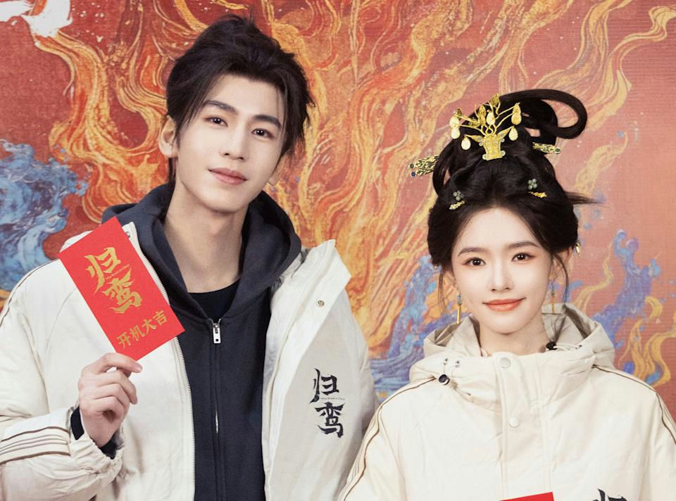 people-male and female actors-A-Chinese historical drama promotion-A-red envelope-A-modern jackets and traditional hairstyle-B-Wang Xingyue and Su Xiaotang (likely cast members of 